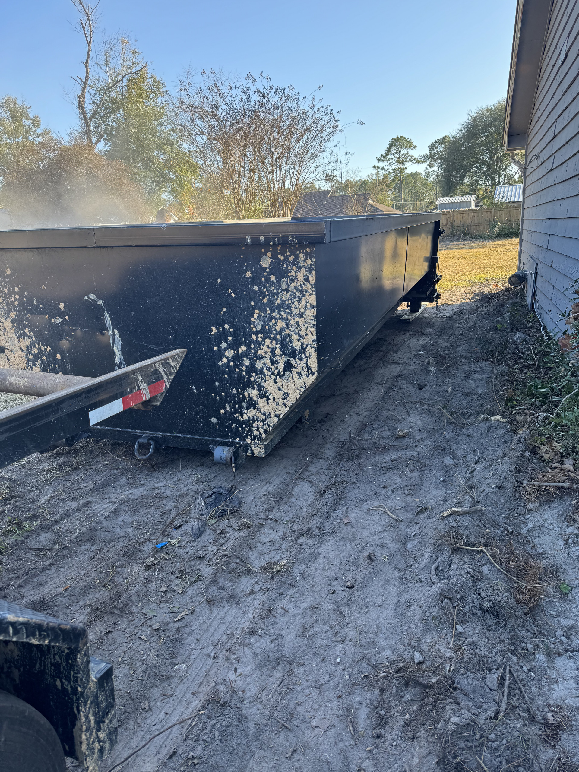 A dumpster being properly moved to help citizens dispose of their waste!